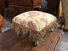 A modern footstool with foliate upholstery, tassels and fringe, on cabriole supports (23cm x 35cm