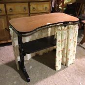 A trestle table with rounded rectangular top with a later curtain rail added with curtain, table