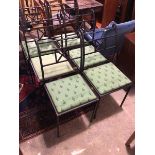 A set of six cast iron garden chairs in a Regency style painted black, all with green drop in seats,