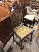 A Charles II style side chair, with elaborate foliate carved back above a cane seat, on turned