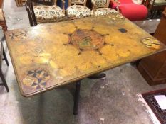 A 1920s/30s table, the top painted a faux marble with the Windsor coat of arms and other coats of
