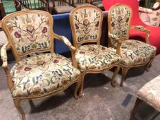 Three Louis XV style beech chairs including two fauteuil, one larger, and a side chair, all in a