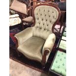 A Victorian mahogany spoon back low chair, with button back, scroll arms with moulding to ends,