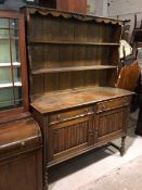 A 1920s/30s dresser, the top with moulded apron above two plate racks, the rectangular top with