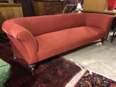 A late 19thc/early 20thc. sofa in a red wave pattern fabric upholstery, with curved back and arms,