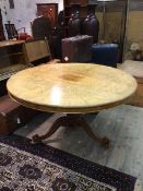 A Victorian breakfast table with circular walnut top, plain frieze, on turned support with carved