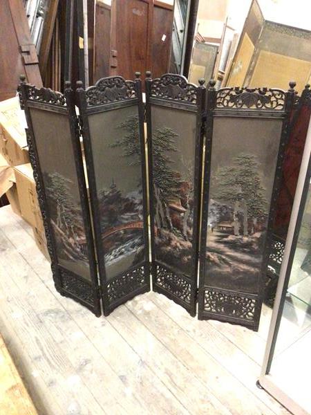 A 1920s four fold Chinese screen, each section with pierced foliate surmount, above painted