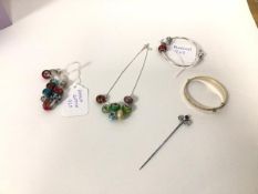 A collection of costume jewellery, including a rolled gold bangle, a Victorian hatpin by Charles