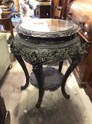 A large Japanese ebonised urn stand, late 19thc., the circular top with pierced border and