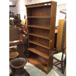 An open bookcase, fitted six shelves, on plinth base, stamped The Oxford Sectional Bookcase (195cm x