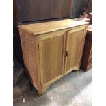 A side cabinet, first half of the 20thc., the rectangular top with moulded edge above two cupboard