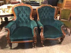 A near pair of Victorian library chairs, both with button backs and arms, in teal upholstery with