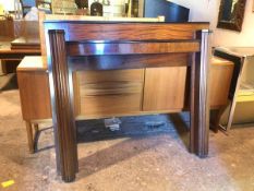 An Art Deco mahogany fire surround, with fluted pillars supporting a bow front mantel (121cm x 140cm