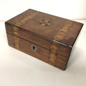 A 19thc hinged box, with walnut veneer, speciman wood bands and central rosette to top, fitted