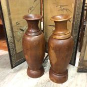 A near pair of carved hardwood vases, of baluster form (one a/f) (80cm)