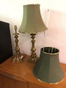A pair of modern brass table lamps, in the rococo taste, in the form of candlesticks, with green