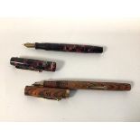 A Parker pen, nib marked Parker 14k pen n with a rose coloured mother of pearl exterior (13cm) and