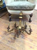 A reproduction composition chandelier with five scroll arms, terminating in drip trays and