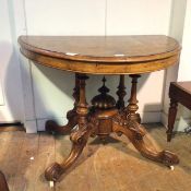 A Victorian loo table, the walnut top (alterations), on four turned supports, with cabriole legs