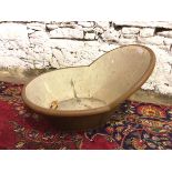 An early 20thc painted metal bath with raised hooped back (42cm x 58cm x 75cm)