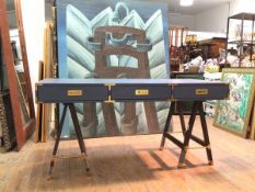 A contemporary campaign style desk, blue painted, with brass style detail, fitted three frieze