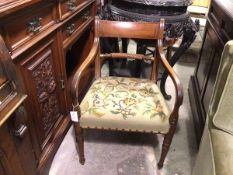 A Regency mahogany armchair with tablet top rail and turned back rail, with tapestry seat, on turned