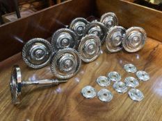 A set of ten silver effect curtain holds, with circular finials (each: 10cm x 8cm)