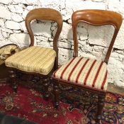 Two Victorian mahogany balloon back chairs, both with floral upholstery on turned front supports (