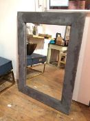 A contemporary wall mirror, in a upholstered padded frame, bears Morris Mirrors label verso (117cm x
