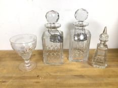 A pair of decanters, with silver labels, one Whisky, one Sherry (26cm) and an etched glass and a cut