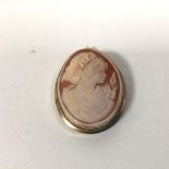 A shell cameo depicting a Young Girl, in a yellow metal casing, marks rubbed (4cm x 3.5cm)