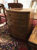 A reproduction Georgian style bow front chest of drawers, the top with moulded edge above four