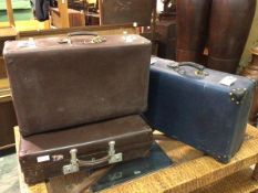 A group of three vintage carrying cases, one blue, stamped Globetrotter (24cm x 72cm x 44cm), two