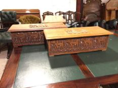 A pair of Indian carved boxes, both with elephants in relief carved to hinged lids, unfitted