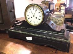 An Edwardian slate mantel clock, the circular dial with roman numerals, on scroll supports and