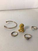 A group of yellow metal jewellery and a yellow metal figure (2.5cm), three rings and a bangle (a