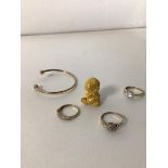 A group of yellow metal jewellery and a yellow metal figure (2.5cm), three rings and a bangle (a