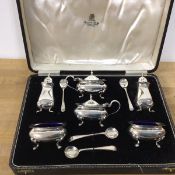 A 1950s silver condiment set including two salts, two peppers, two condiment pots, with associated