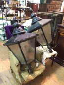A pair of large black painted metal street lanterns, possibly Edinburgh gas lamps of tapering square