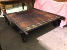 A Howdah style coffee table, with wooden top, flanked by sheet metal panels, with matching sides and
