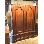 A Victorian mahogany wardrobe, with two panelled doors flanked by columns, with hanging space,