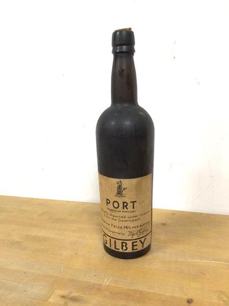 A Gilbey bottle of port, inscribed Specially Imported under Licence from the Government (31cm), fill