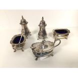 A Walker & Hall condiment set with two pepperettes (10cm), two salts with spoons and a mustard pot