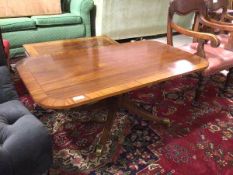 A reproduction mahogany Regency inspired coffee table, the rectangular top with rounded edges on