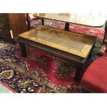 A Chinese low table, with moulded frieze, on square supports with moulded block feet (34cm x 91cm