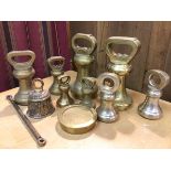 A collection of brass weights, largest 7lb (17cm), a brass bell (11)