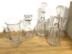A pair of bell glass decanters (each: 31cm), a mallet shaped decanter, etched Sherry, a footed jug