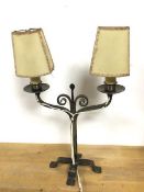 A candelabra style table lamp with two arms, each with drip tray and lampholders, with shades, on