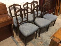 A set of six 1920s Georgian inspired dining chairs, the arched top rail with central rosette over an