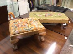 Two 1920s/30s footstools, one with a drop in tapestry seat (24cm x 42cm x 33cm), on ball and claw